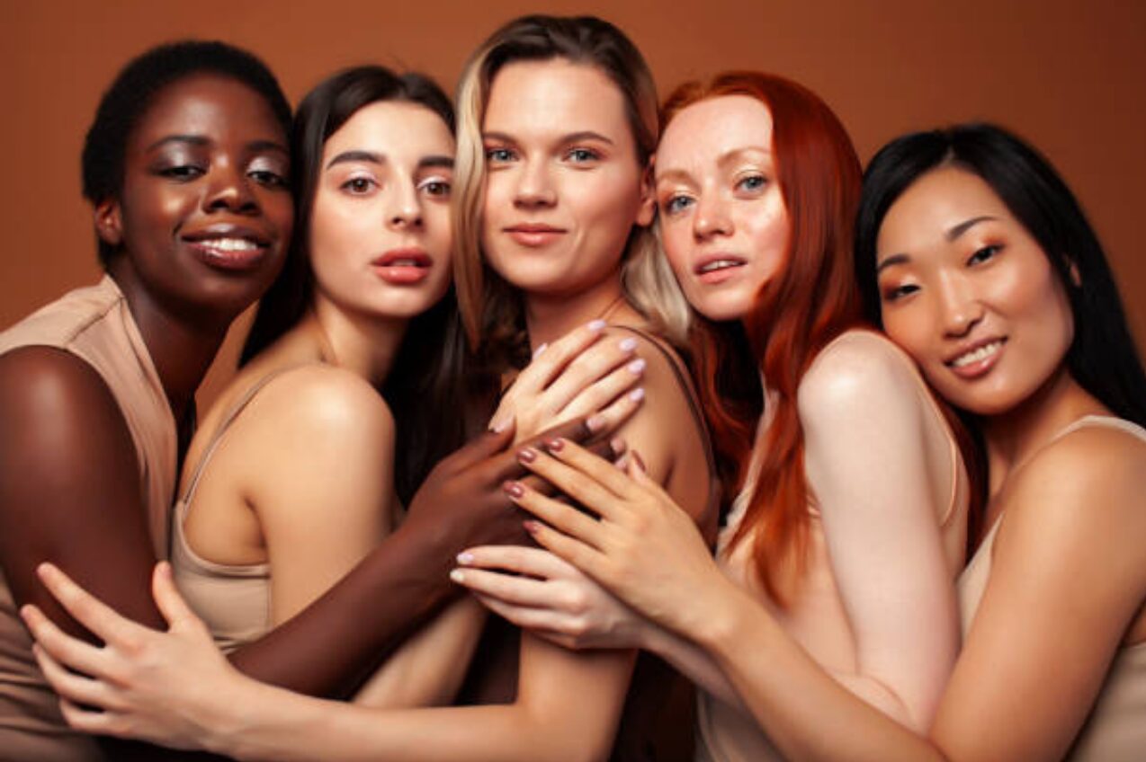 Group of diverse women celebrating beauty and individuality in skin tones and features, highlighting diversity in beauty.